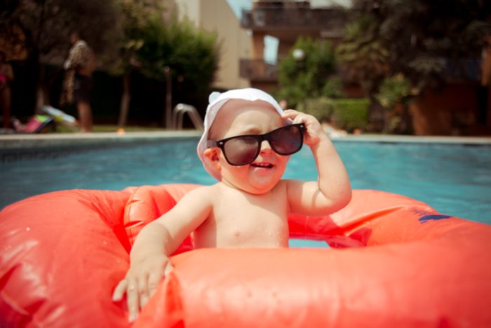 Baby boy wearing sunglasses at the pool