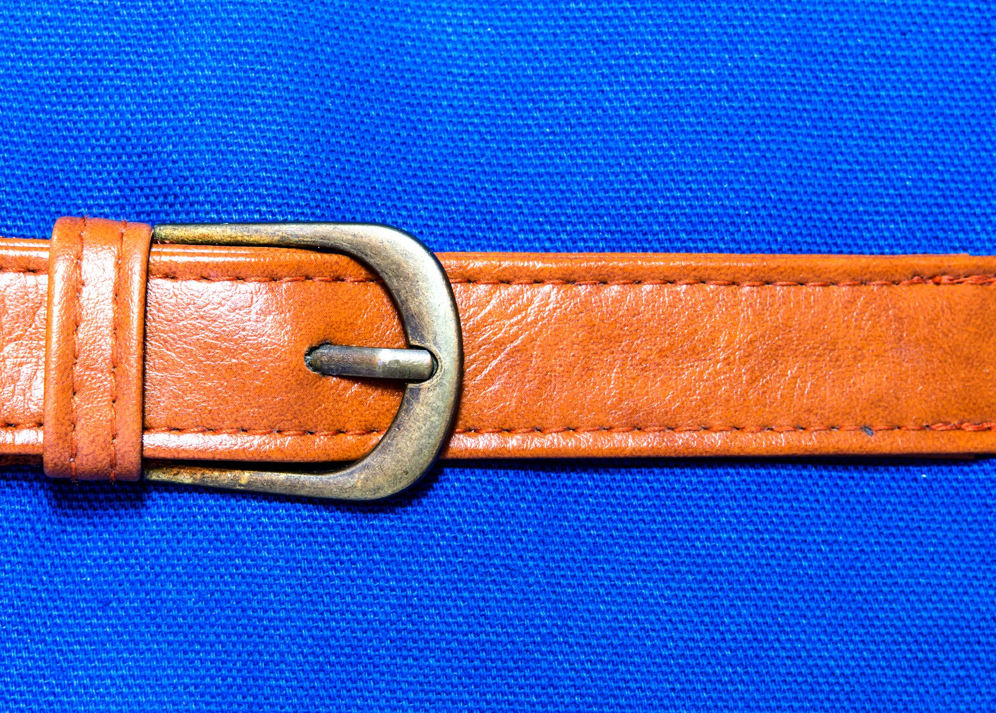 Close-Up Of Belt On Blue Background