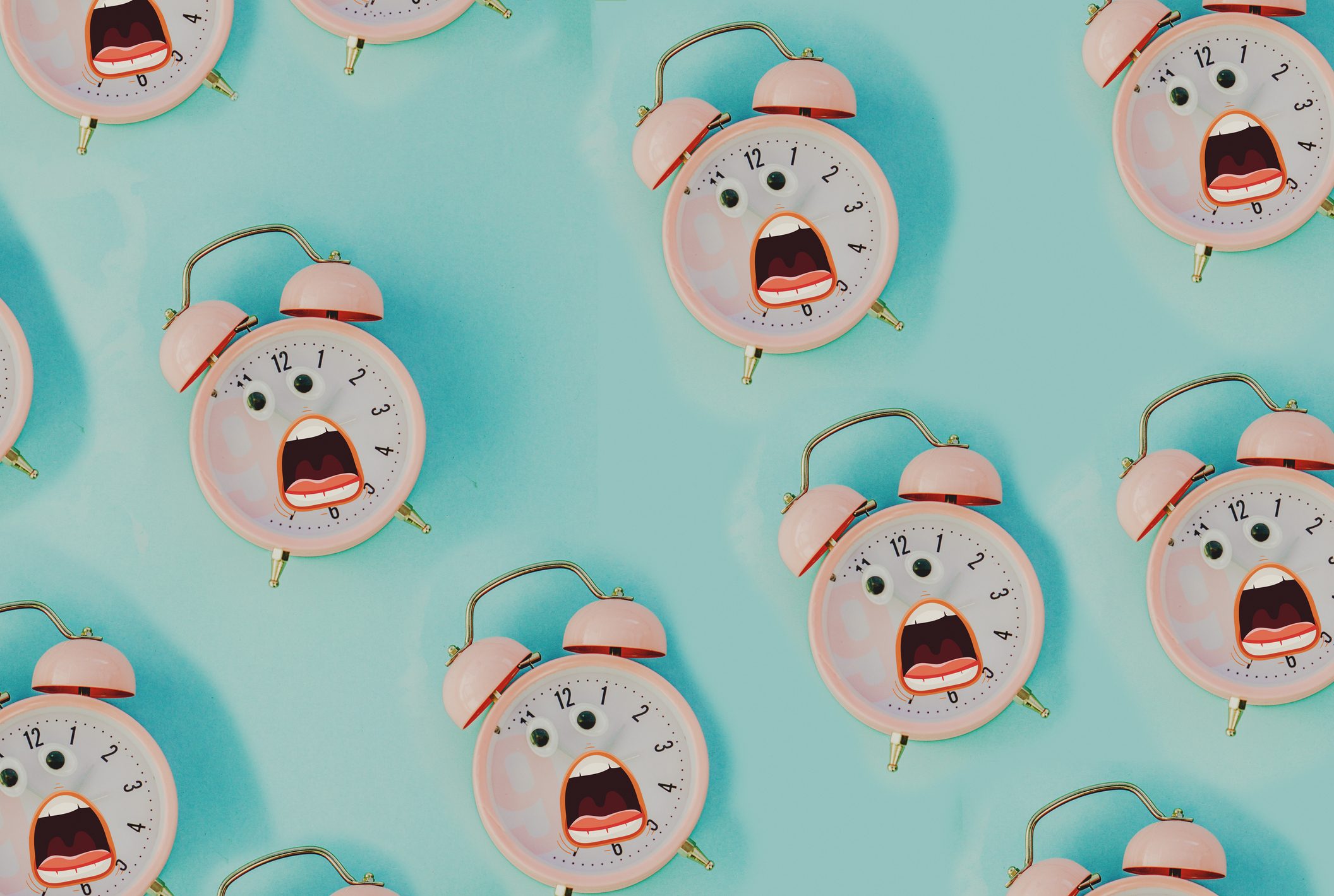 pink alarm clock in pastel colorful background.Top view