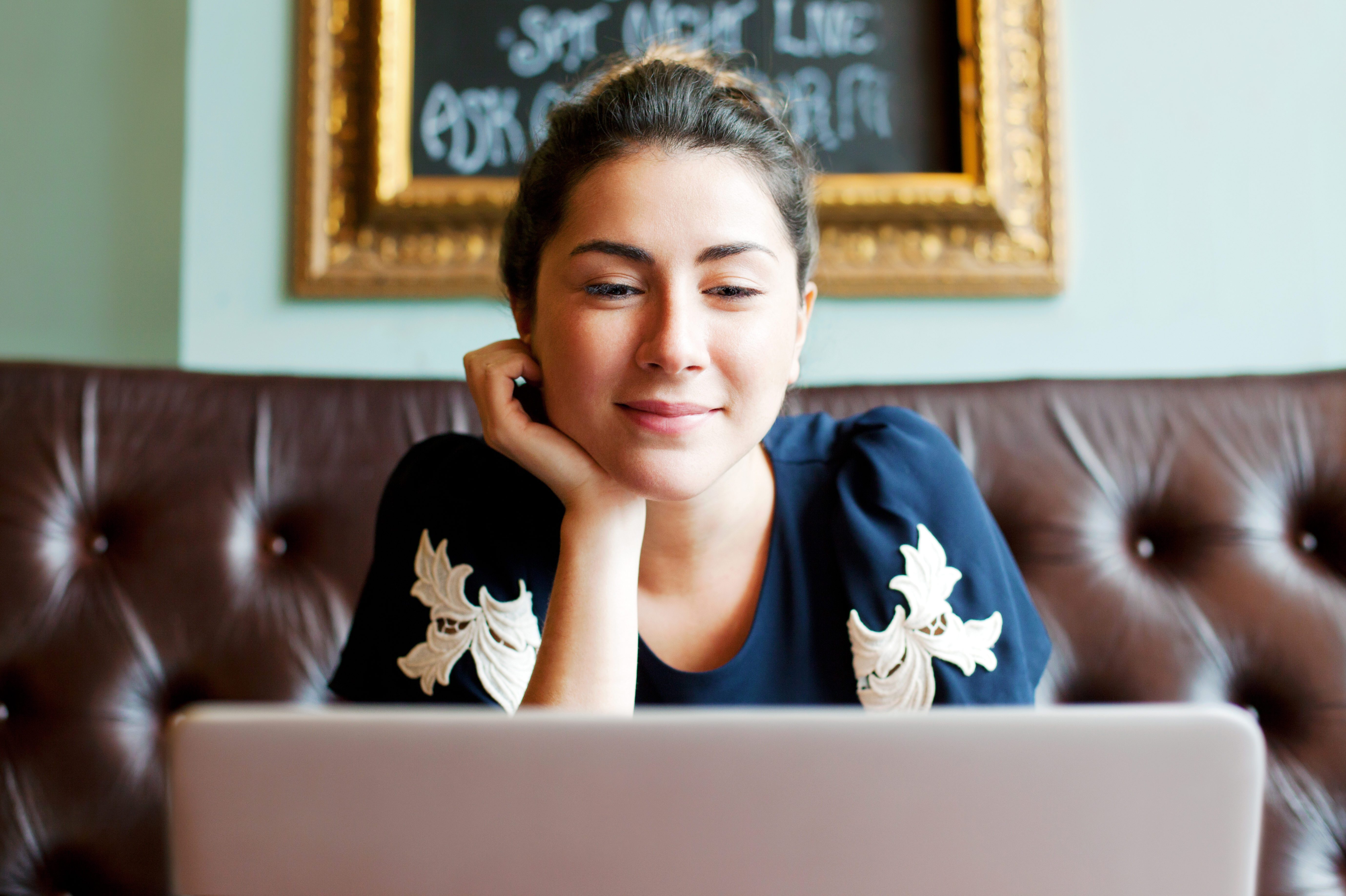 Woman looking at screen in cafe.