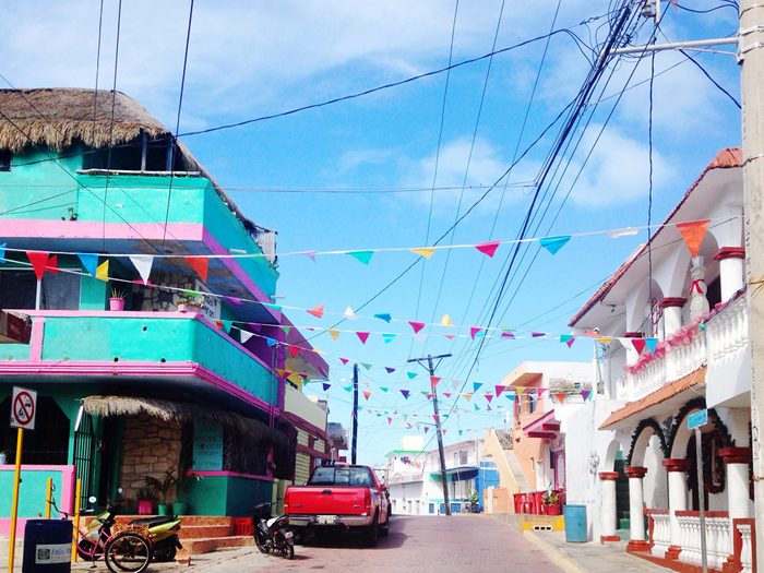 Prayer Flag Hanging Amidst Buildings In City