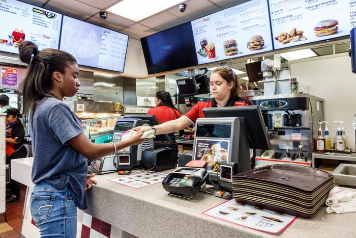 Florida, Vero Beach, McDonald's Fast Food restaurant Cashier giving change to Customer