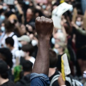 closeup of enclosed fist raised high in crowd