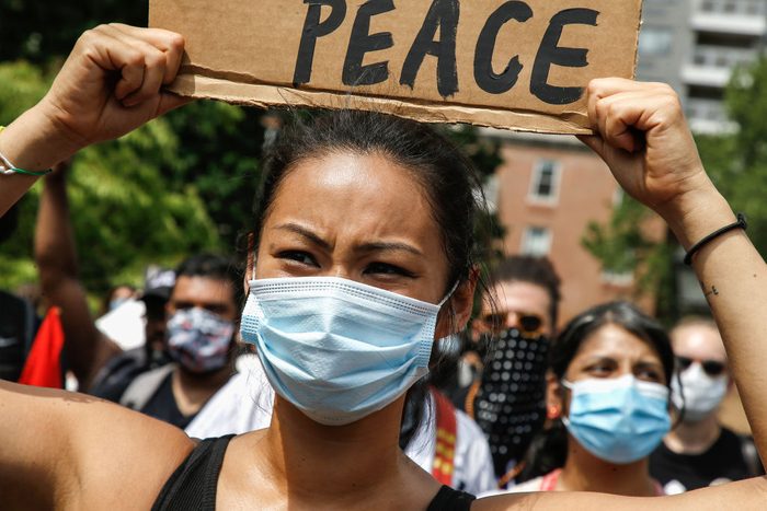 A demonstrator holds a placard during the protest in...
