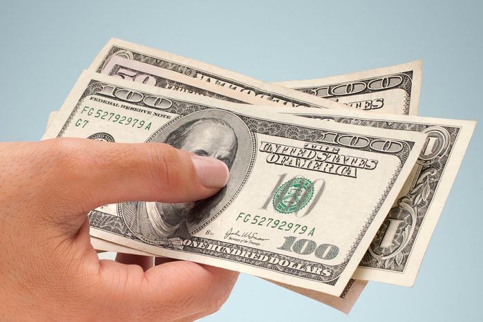 Hand holding American currency