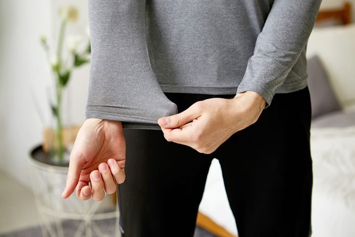 pulling at sleeve of shirt