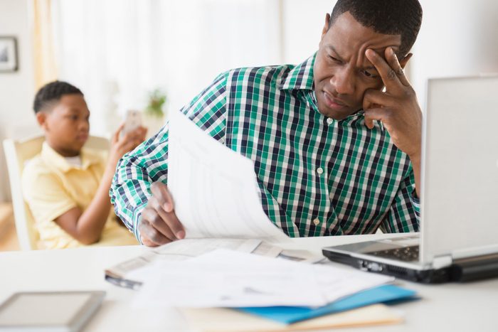 Anxious father paying bills online