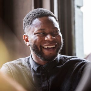 Man in a pub laughing with friends