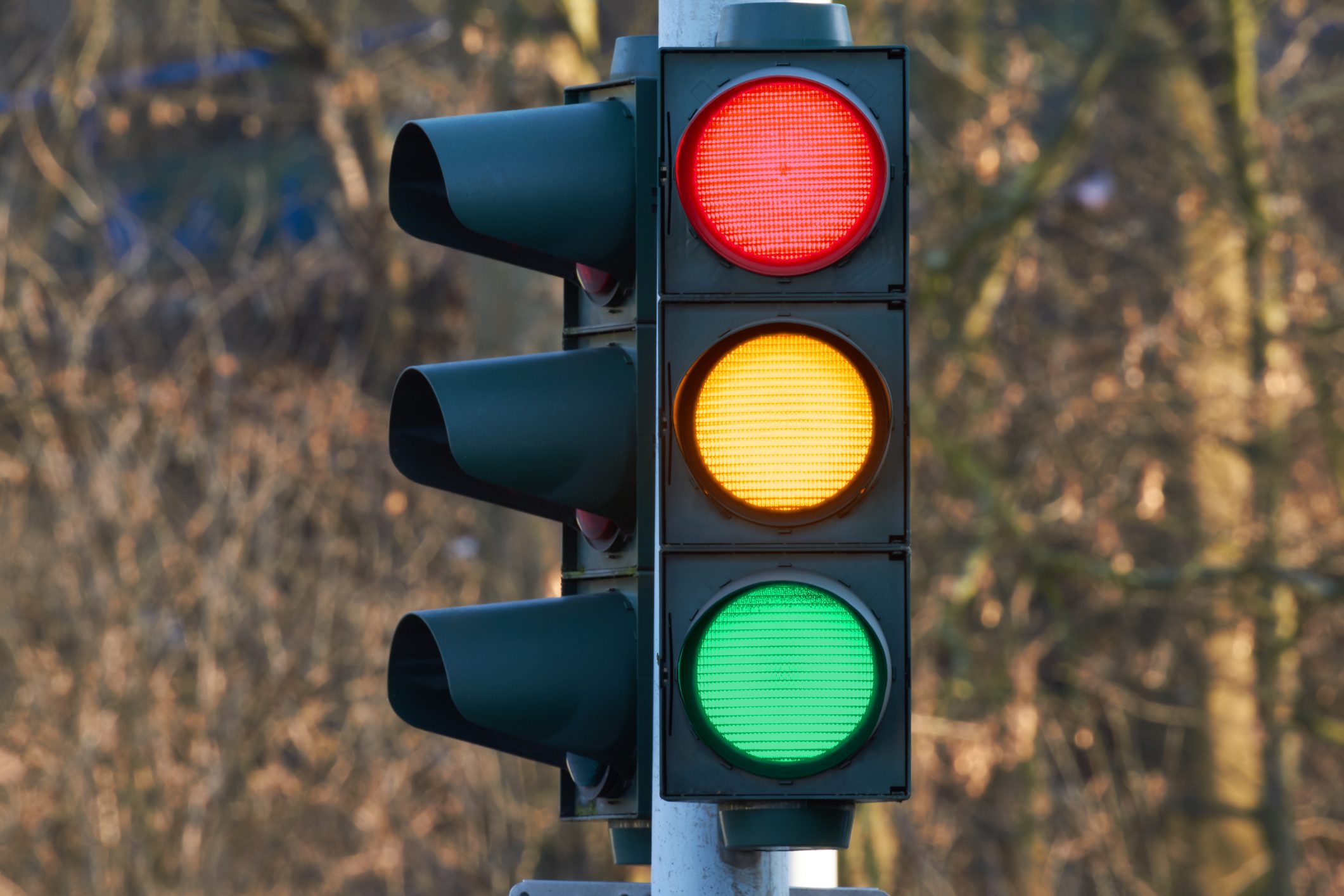 Close-Up Of Road Sign Against Illuminated City