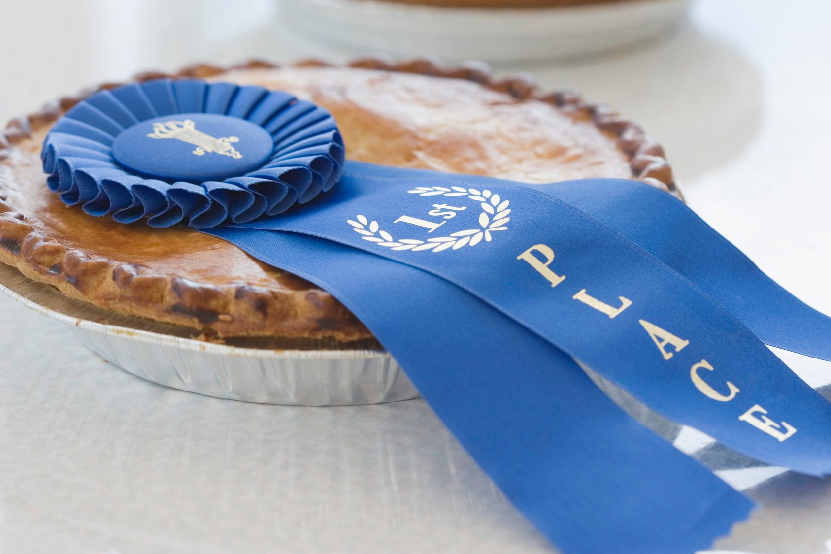 Close up of blue ribbon on pie