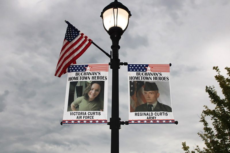 signs honoring veterans and a flag