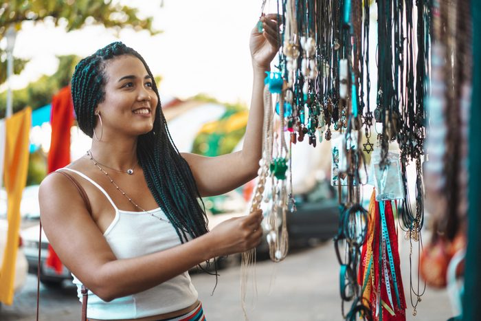 Black woman looking and choosing crafts at Olinda fair