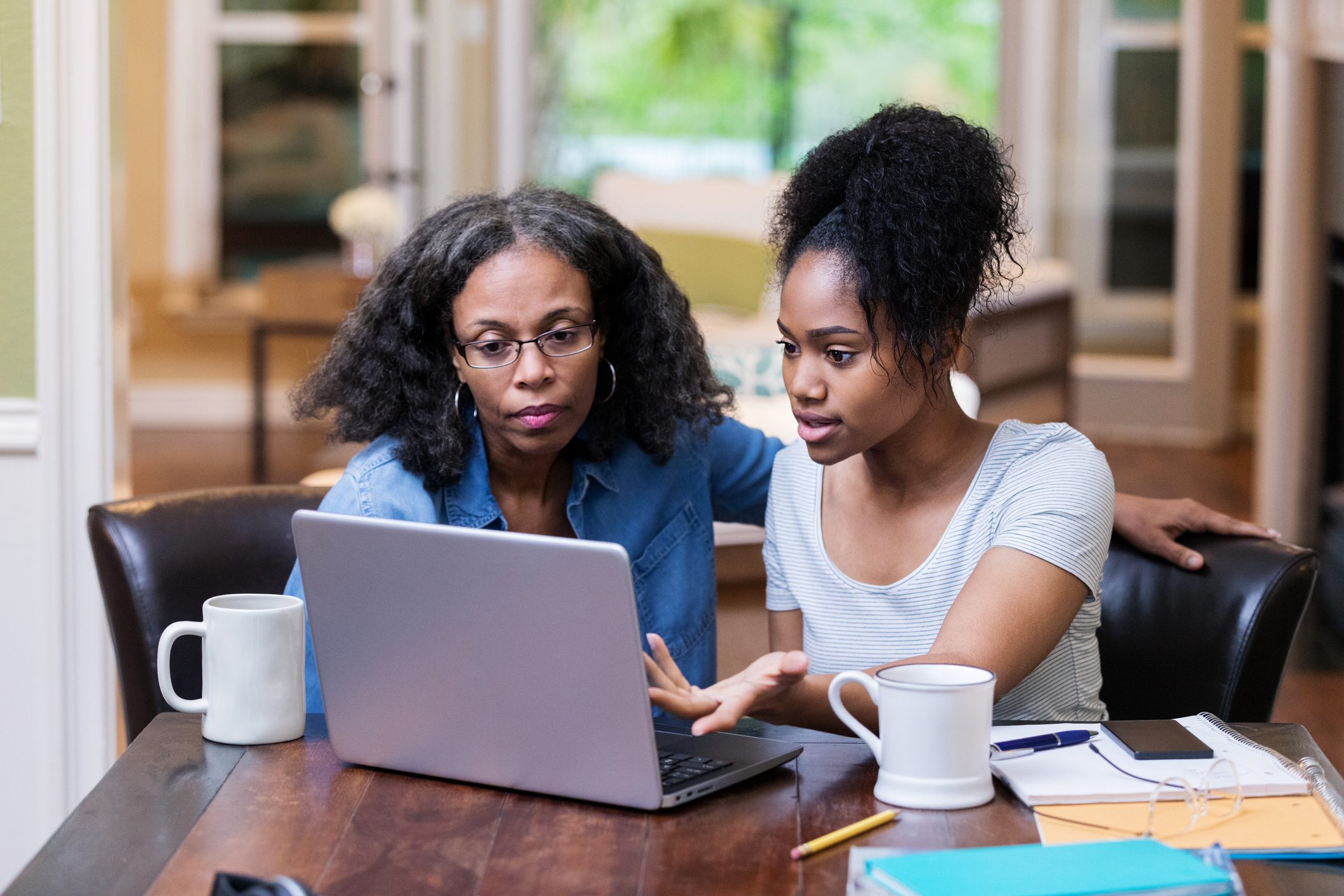 Young woman gestures while using computer