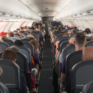 Rear View Of People Sitting In Airplane