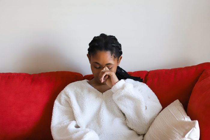Young Woman Sitting On Sofa
