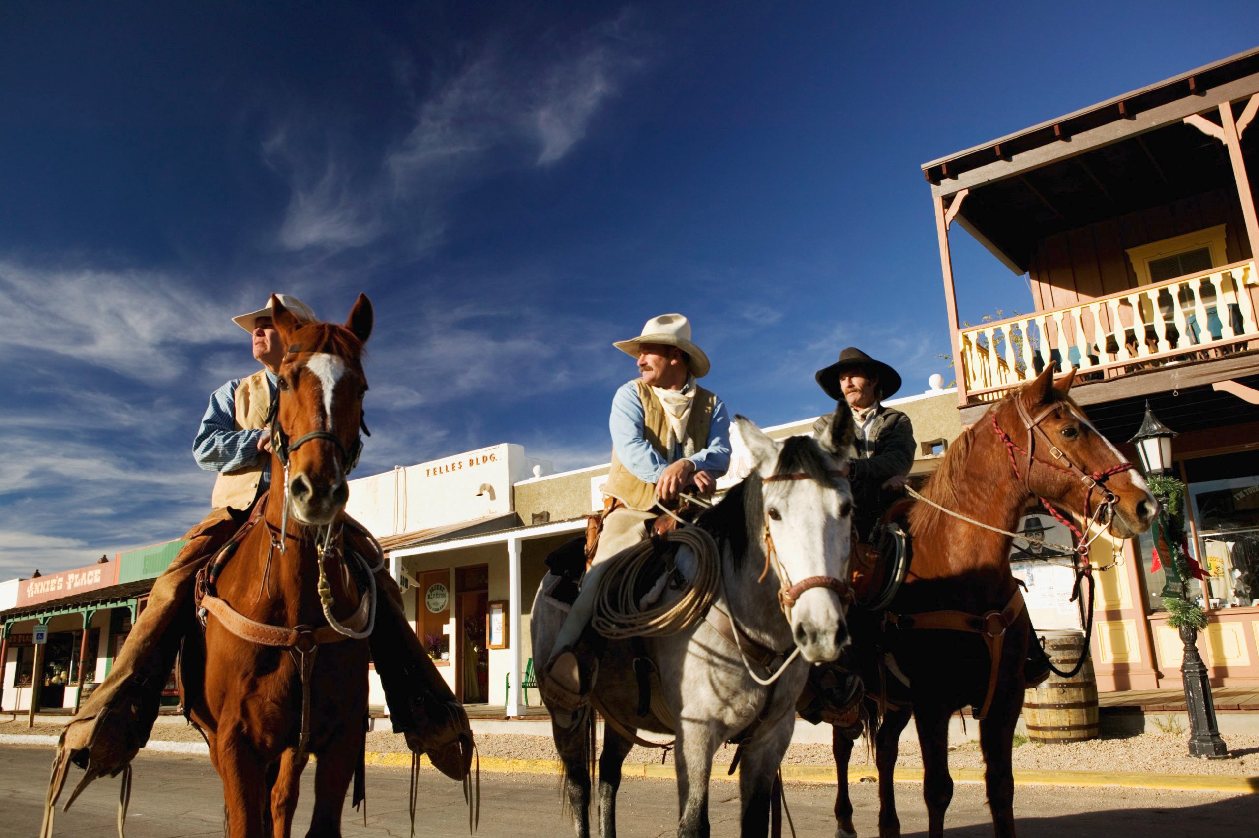 USA, Arizona, Tombstone, three cowboys on horseback