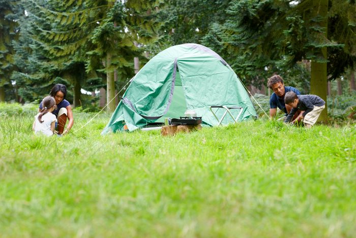 Family setting up tent