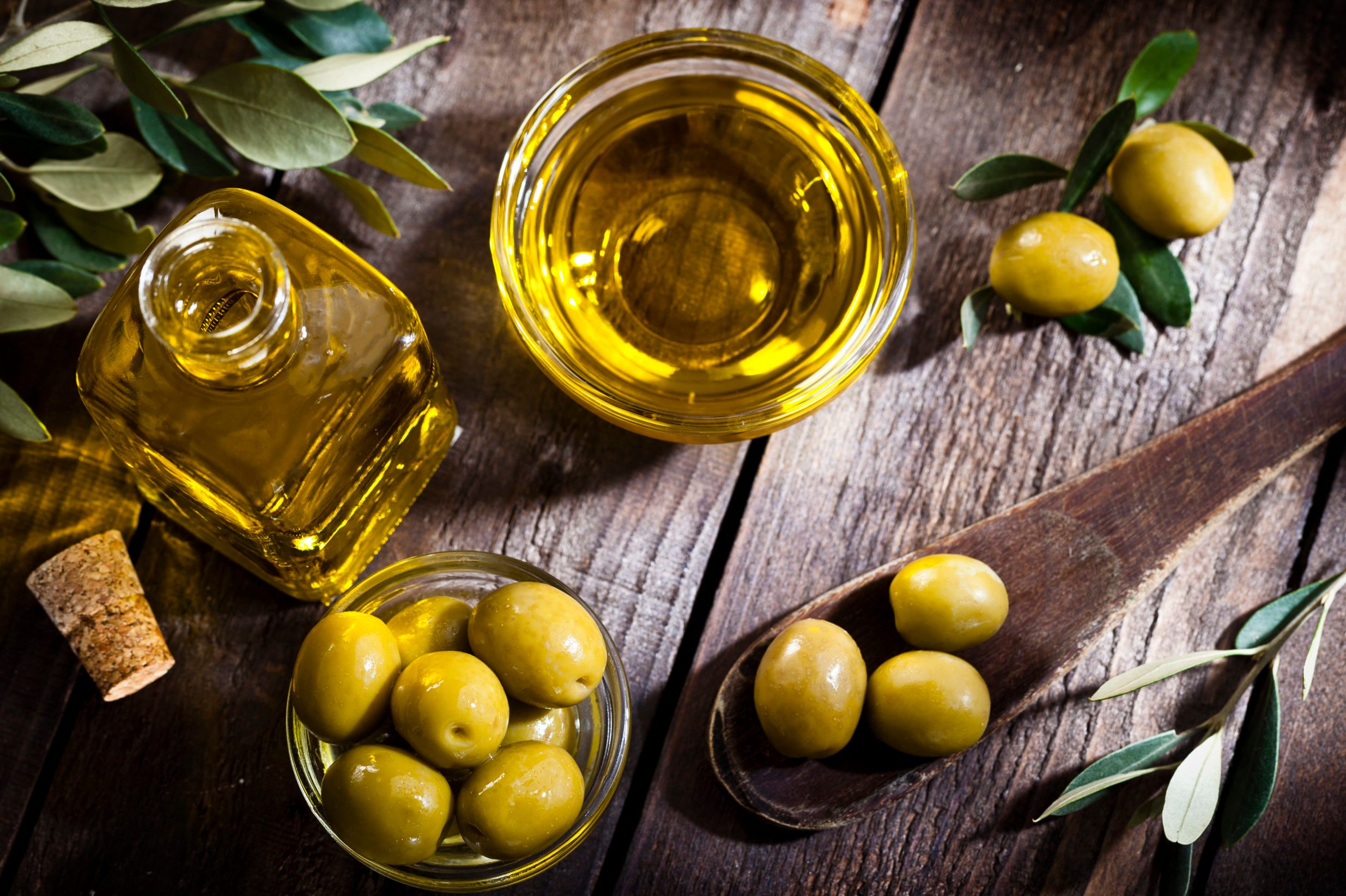 Olive oil and green olives shot from above