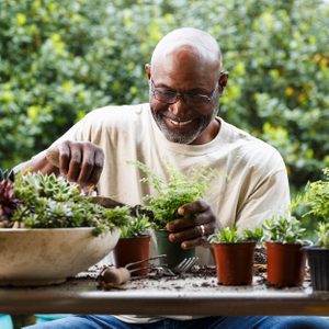 man gardening at table outdoors