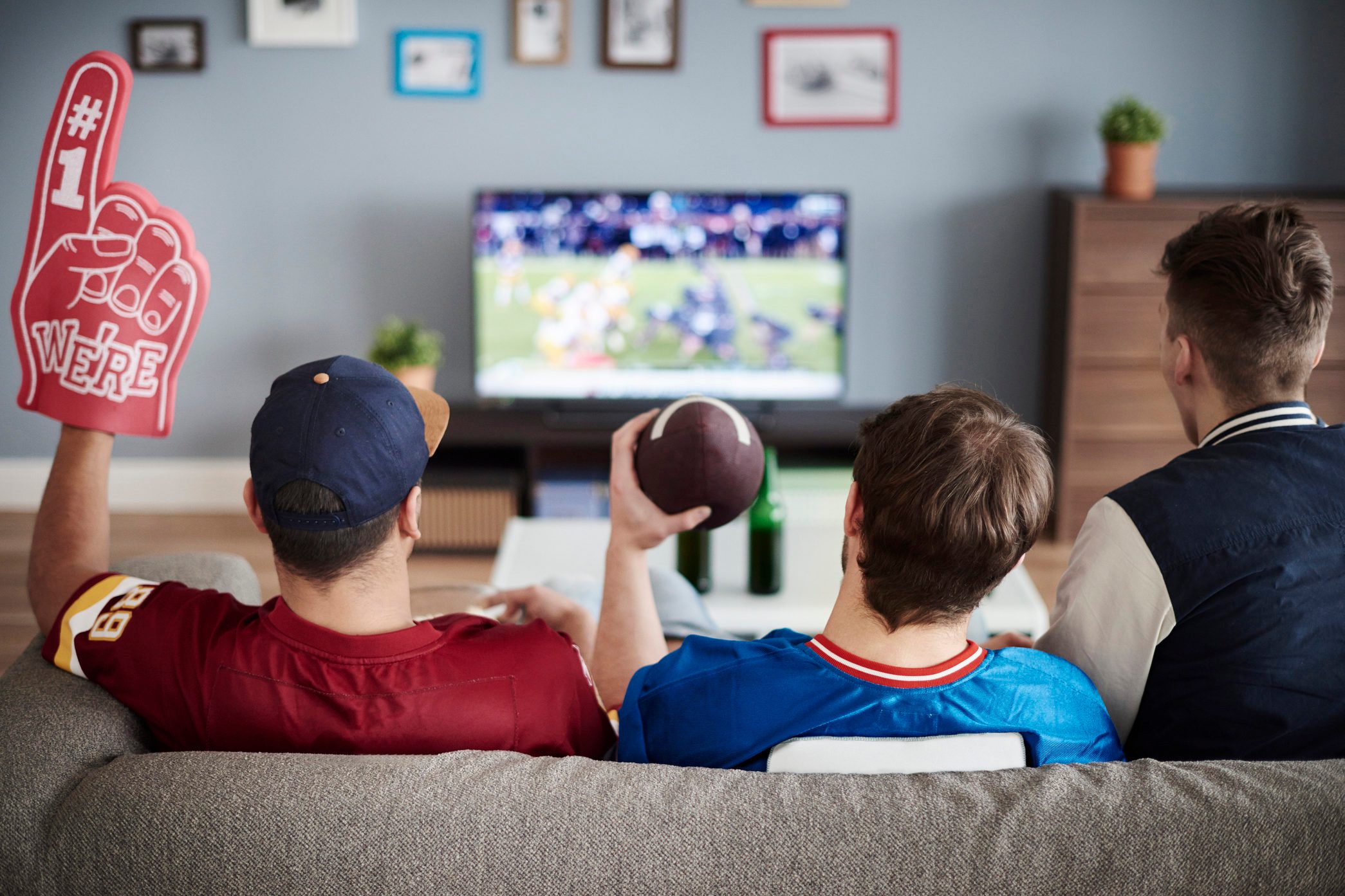 Three men with American football equipment. Debica, Poland