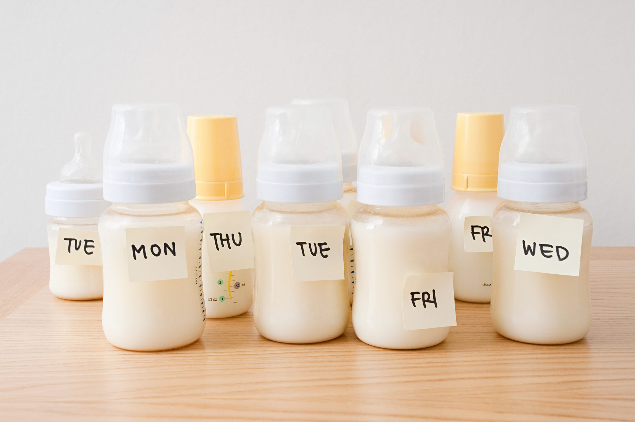 Baby bottles with days of the week on adhesive notes