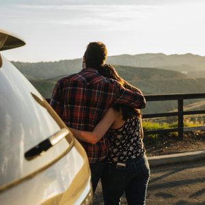 Couple enjoying view of mountains on road trip