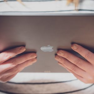 Latest Apple iPad Pro release, held by a woman in a store