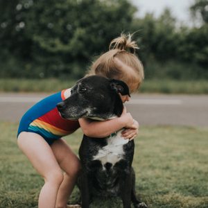Girl hugs Dog