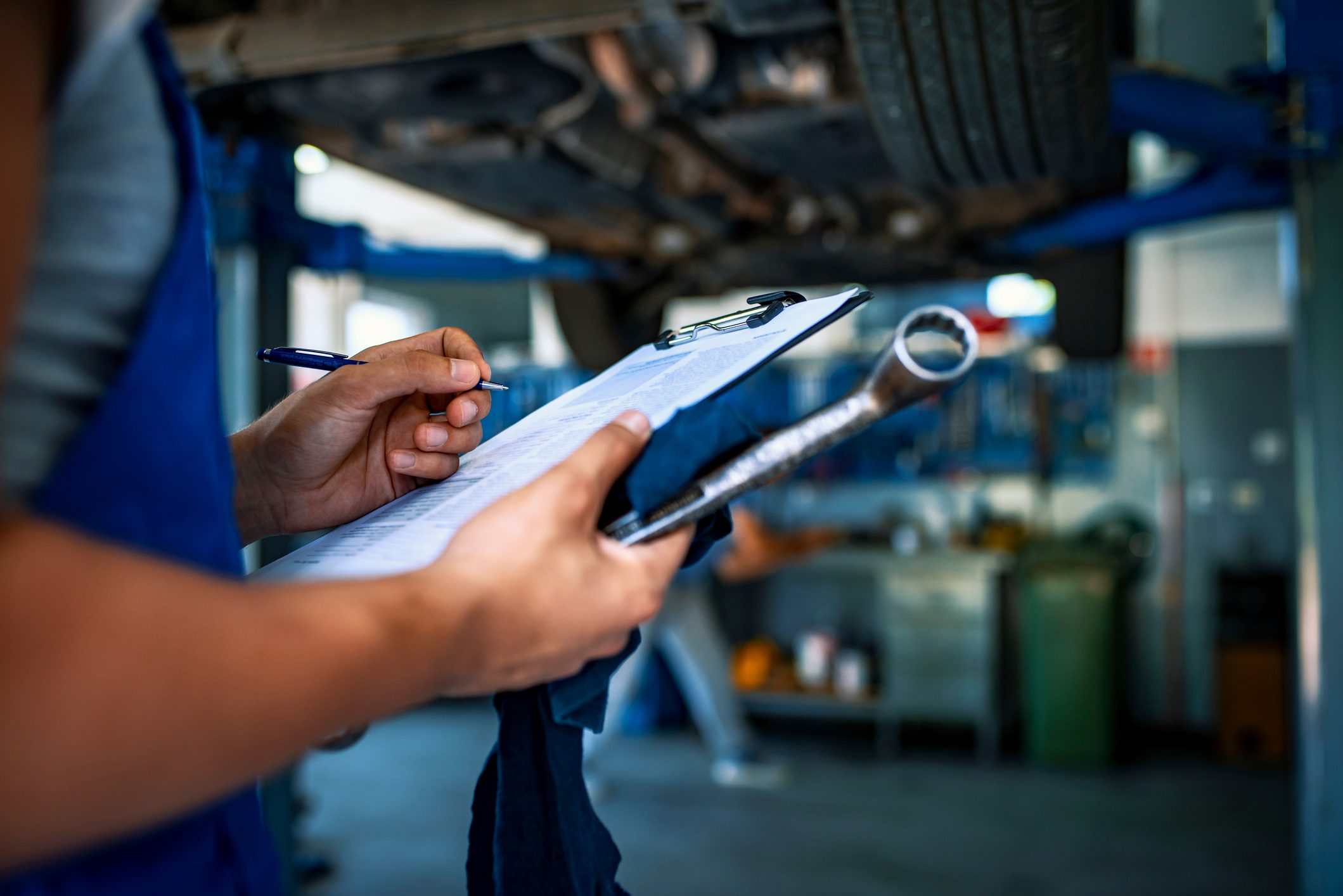 Automotive specialist adjusting an engine