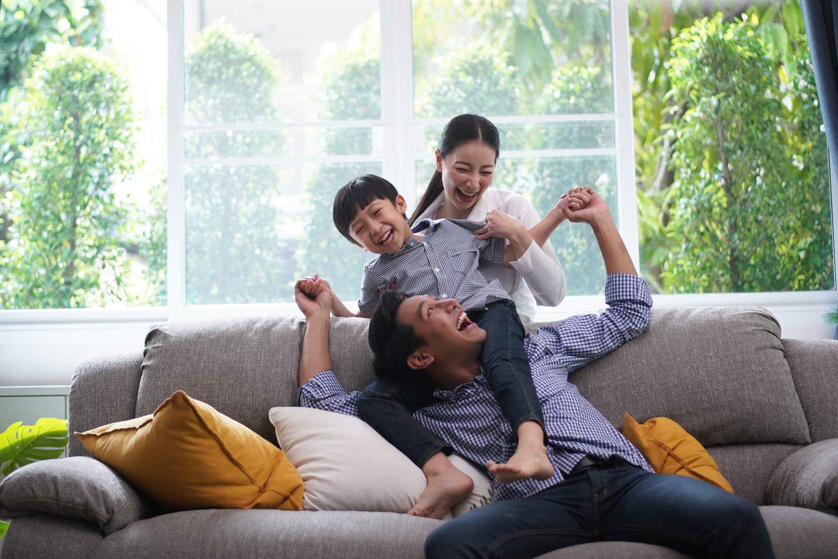 Family playing together father giving his son piggyback ride happiness time together at home