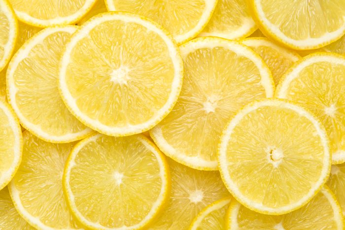 Fresh lemon slices pattern background, close up