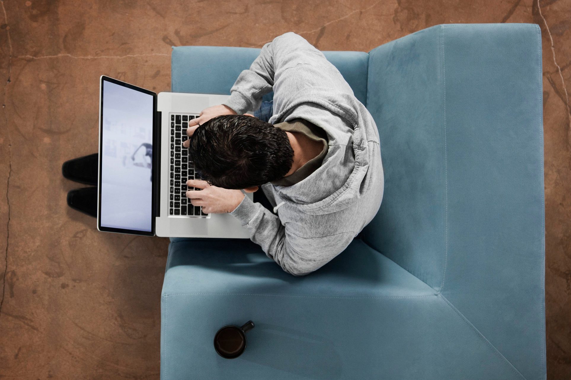 Hispanic man typing on laptop