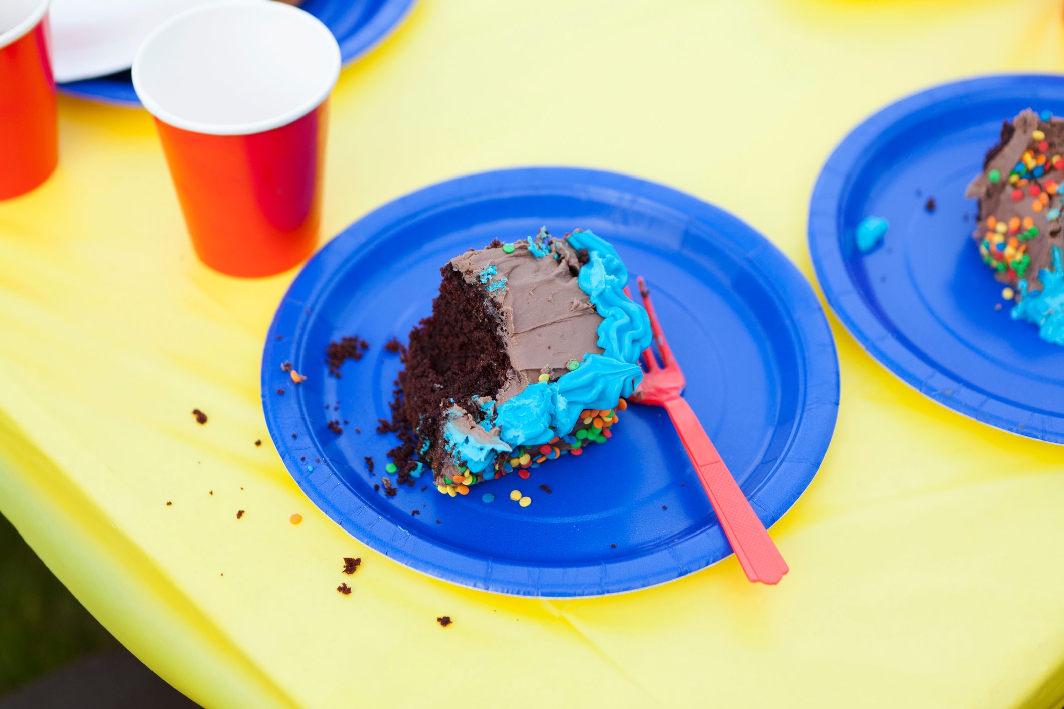 A piece of half eaten cake on a disposable plate