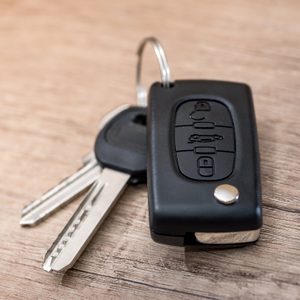 black car key on wooden desk with copy space.