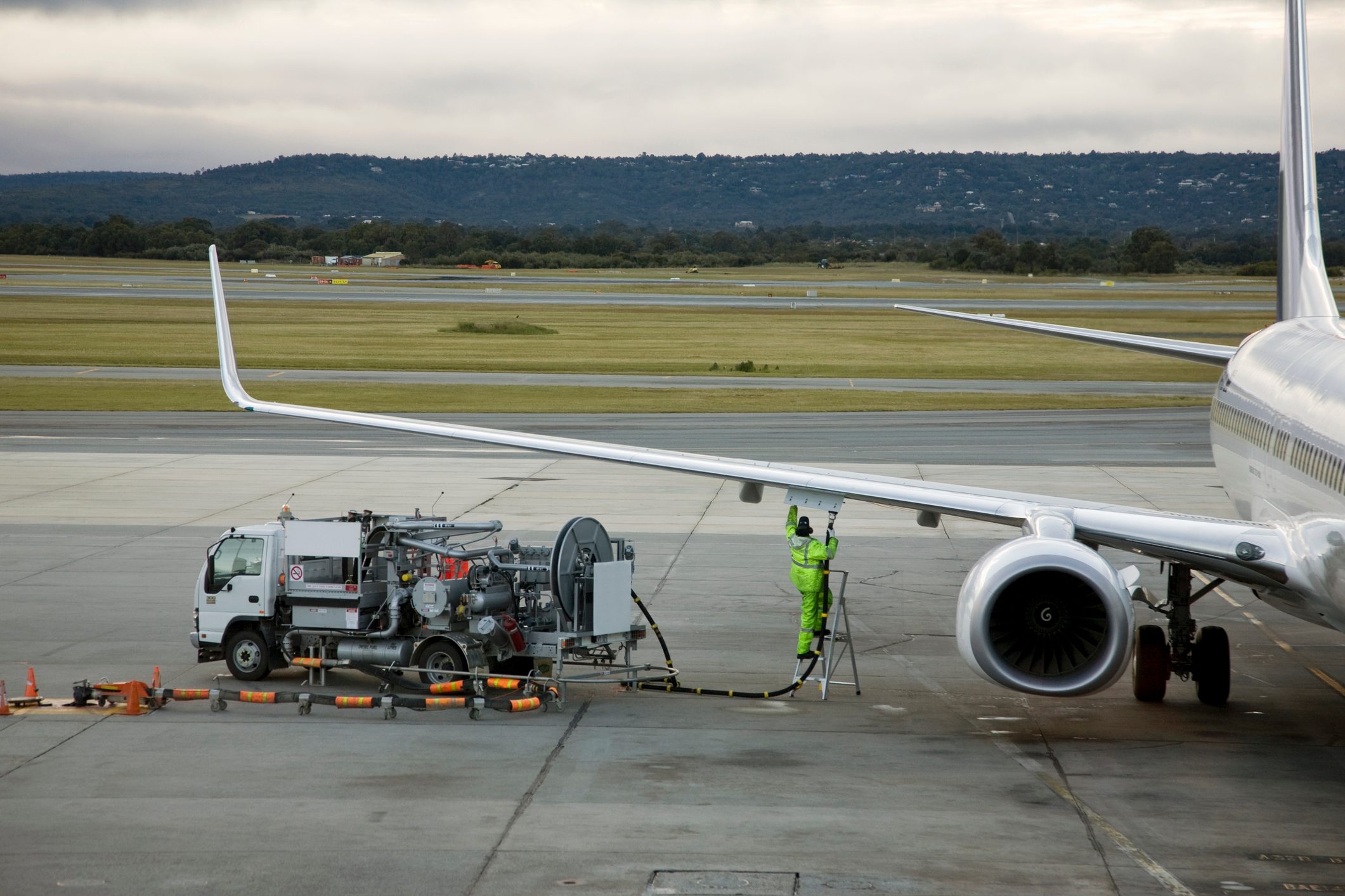 An airplane being refueled on the tarmac