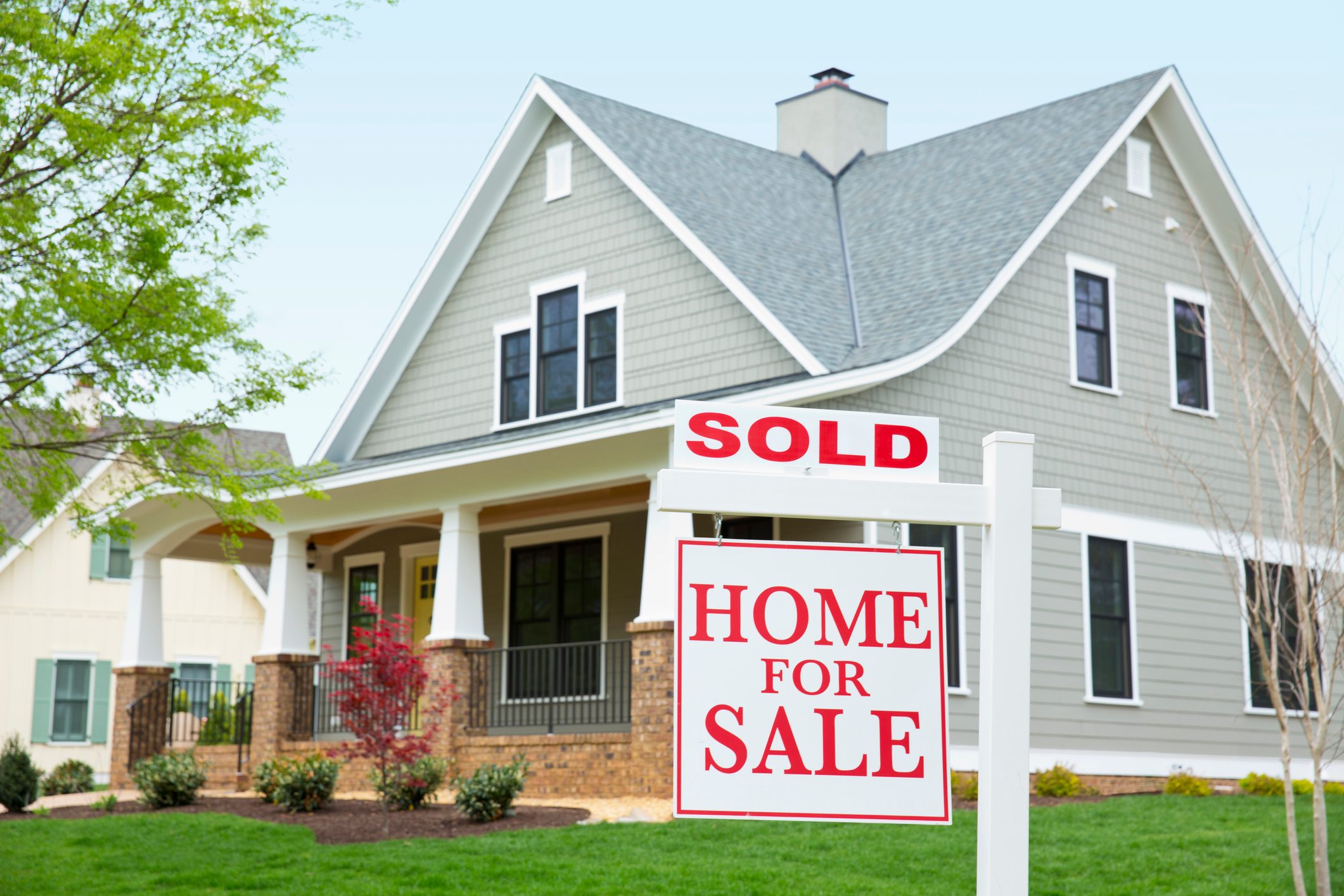 House with ""sold"" sign in front yard