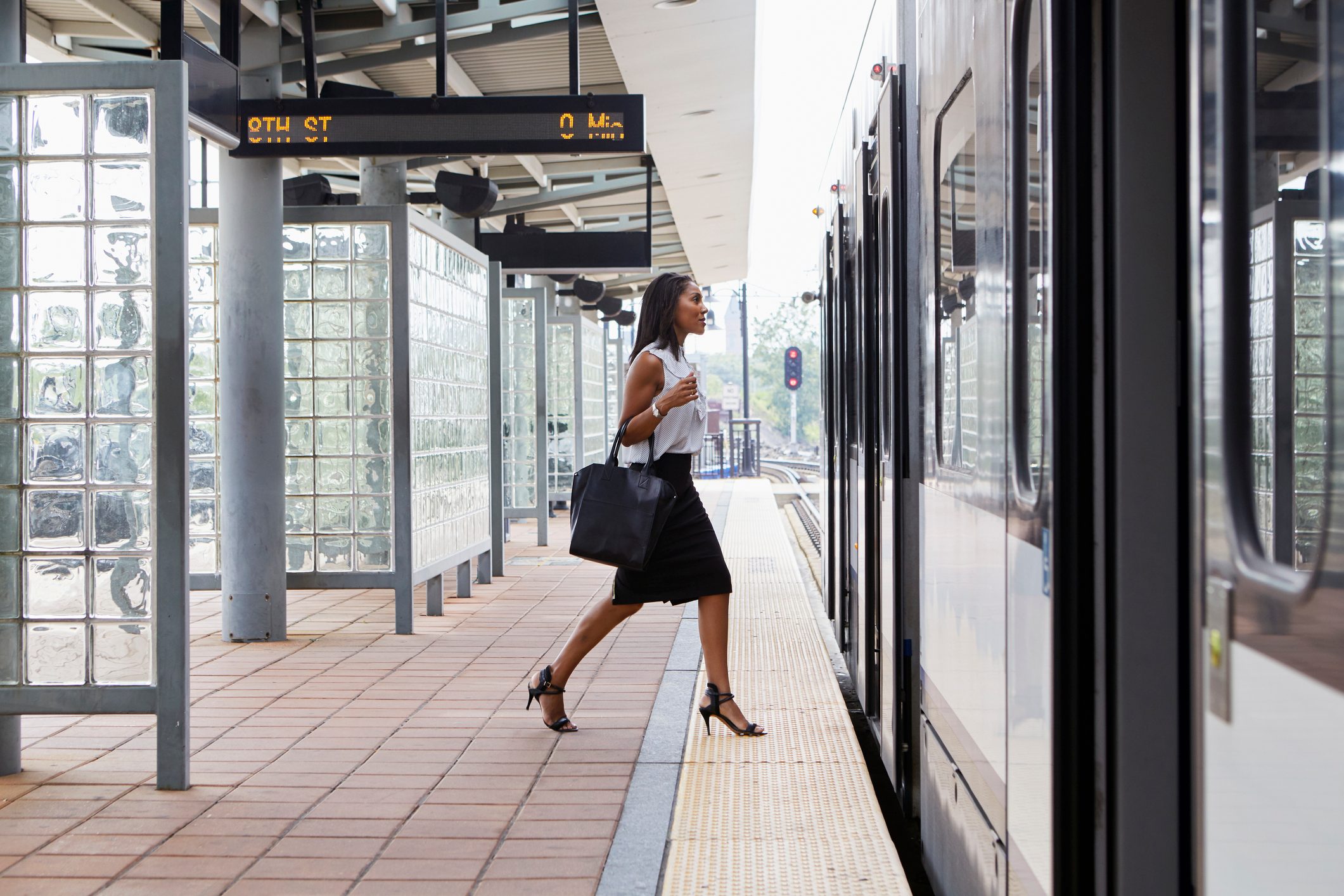 Businesswoman boarding train