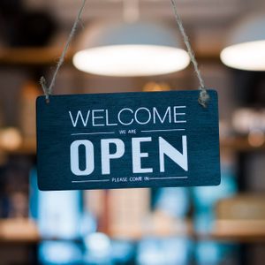 Store open sign hanging on the window