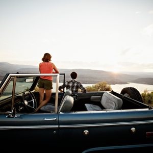 Couple pulled off to side of road watching sunset