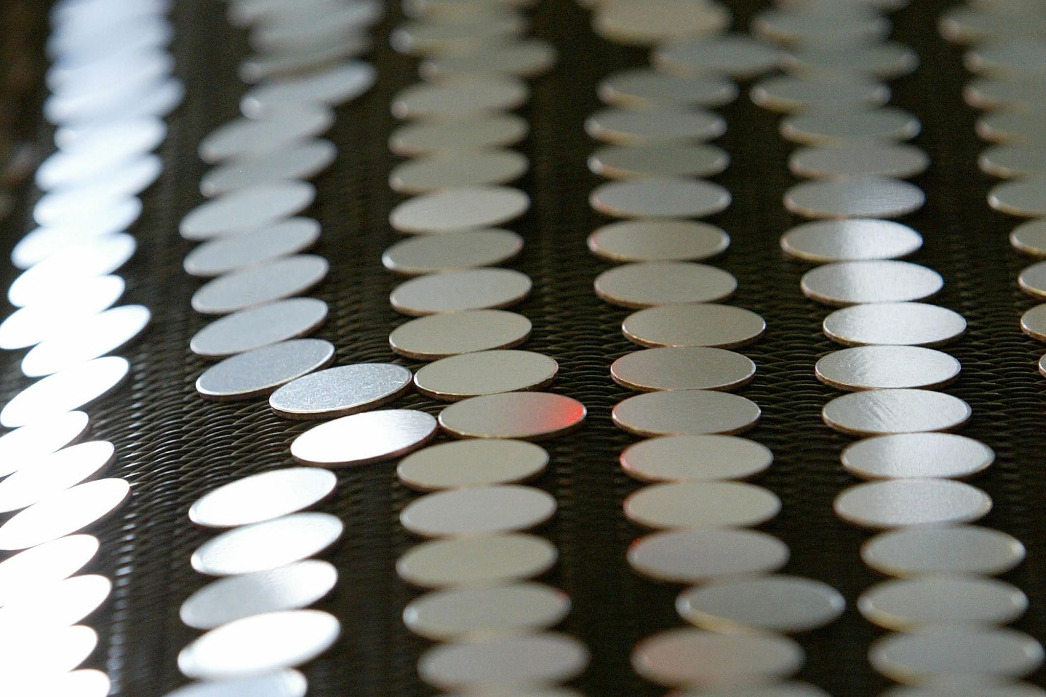 coin blanks on a conveyor belt at a US Mint