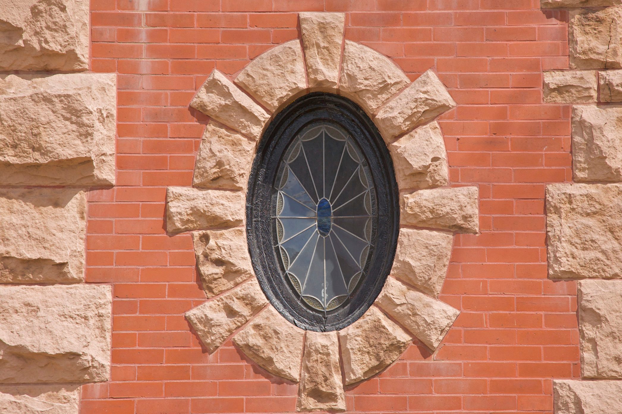 Oval stained-glass window on building facade