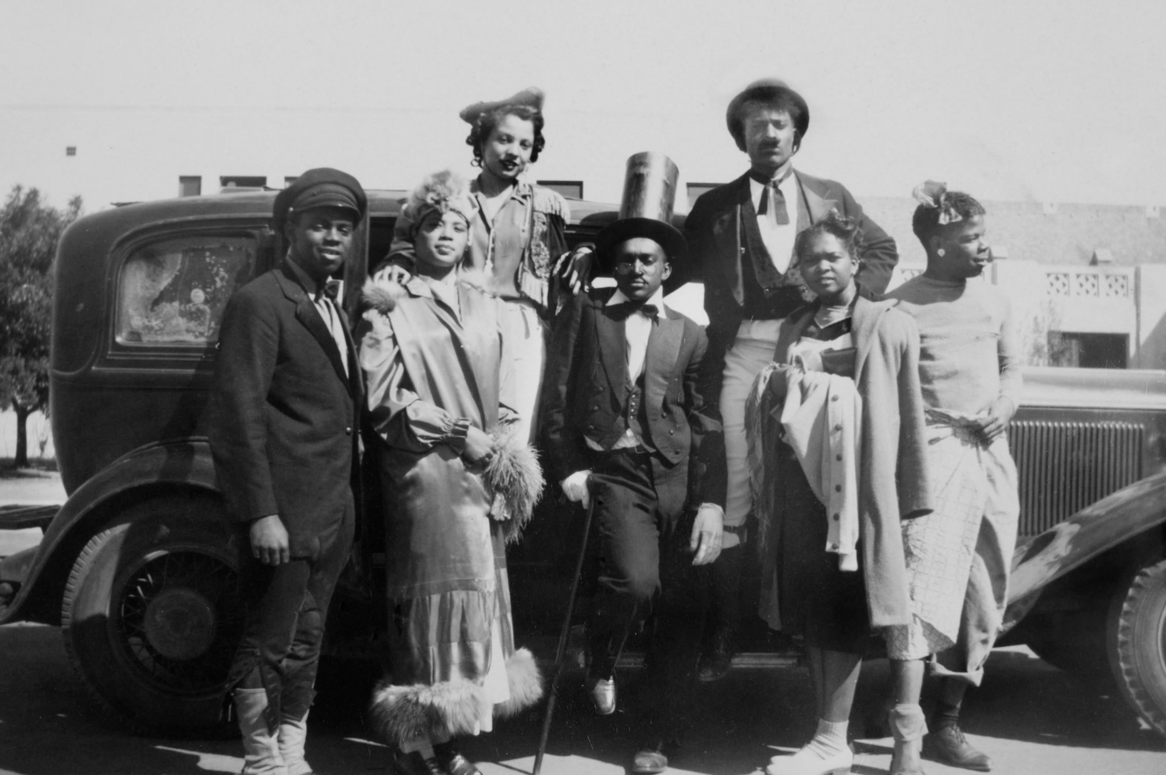 Group of young men and women ready for a costume party, ca. 1930.