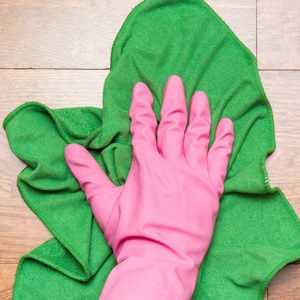 Wooden floors cleaning with rag in the room.