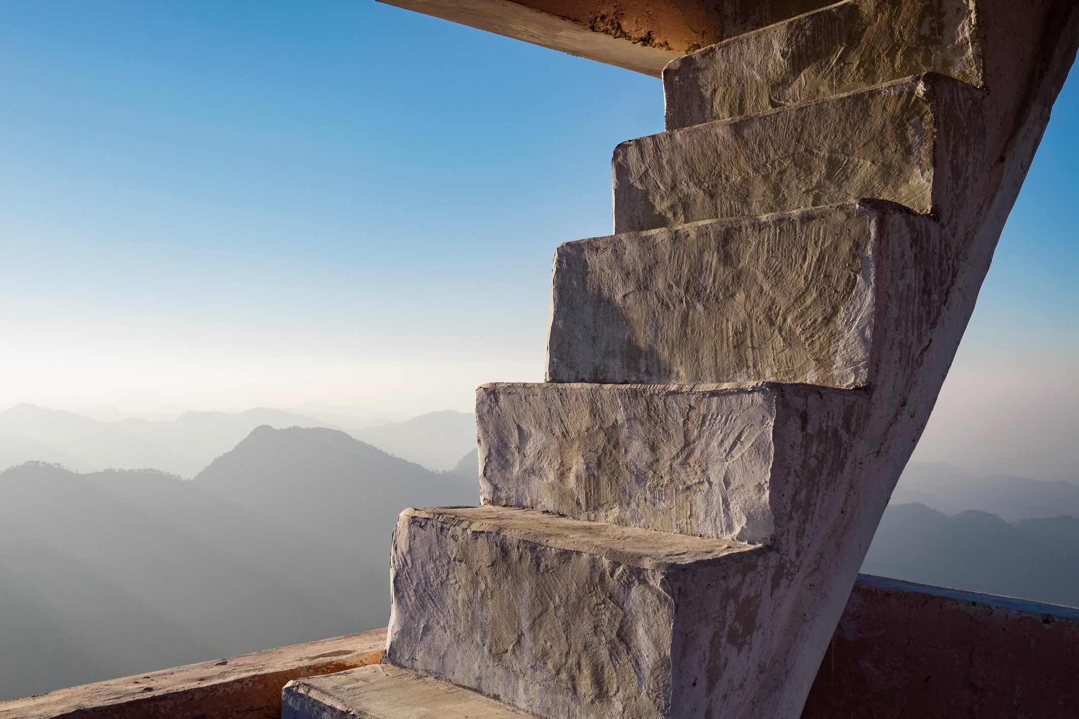 Concrete staircase overlooking scenic view of mountains