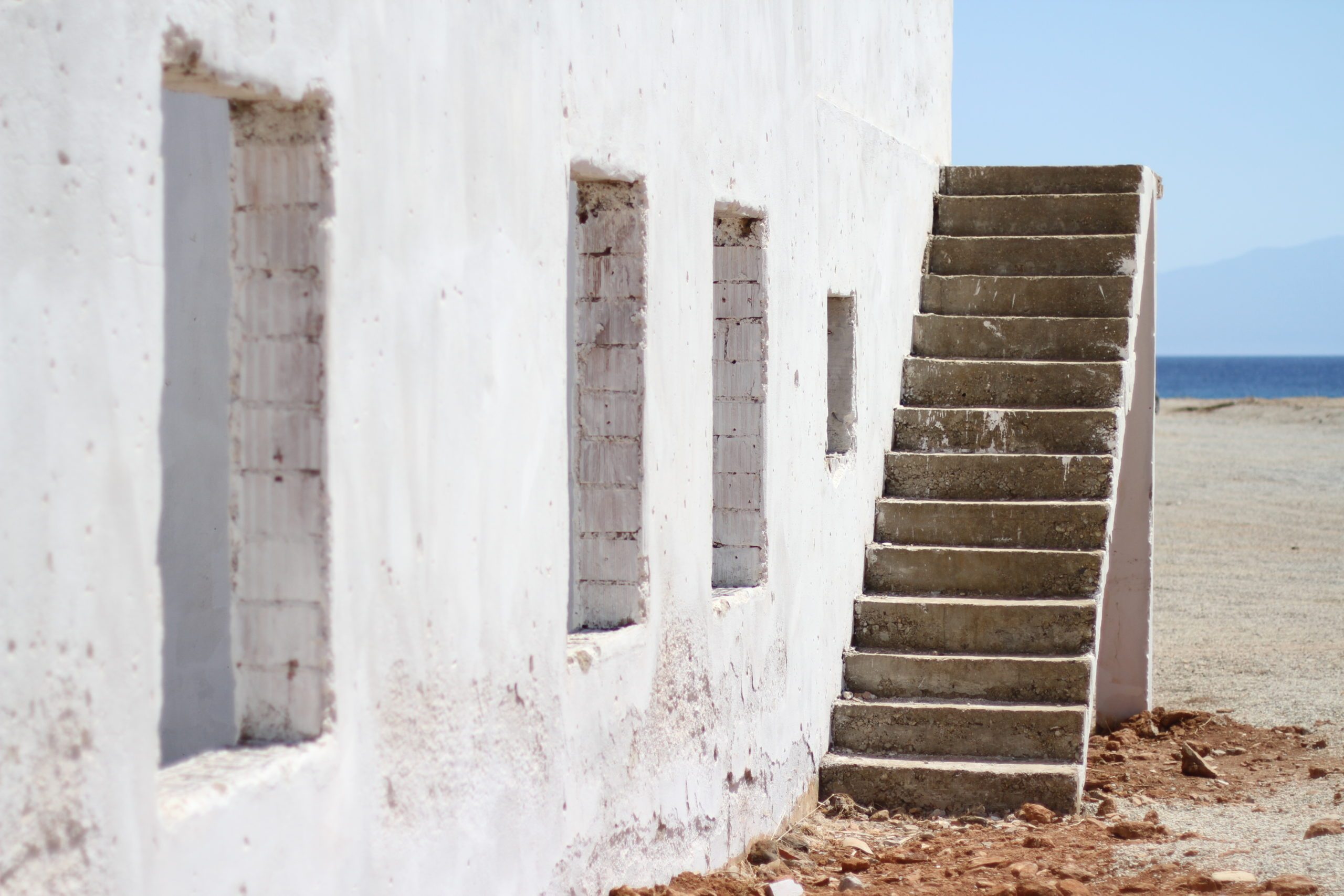 An abandoned beach house with stairs