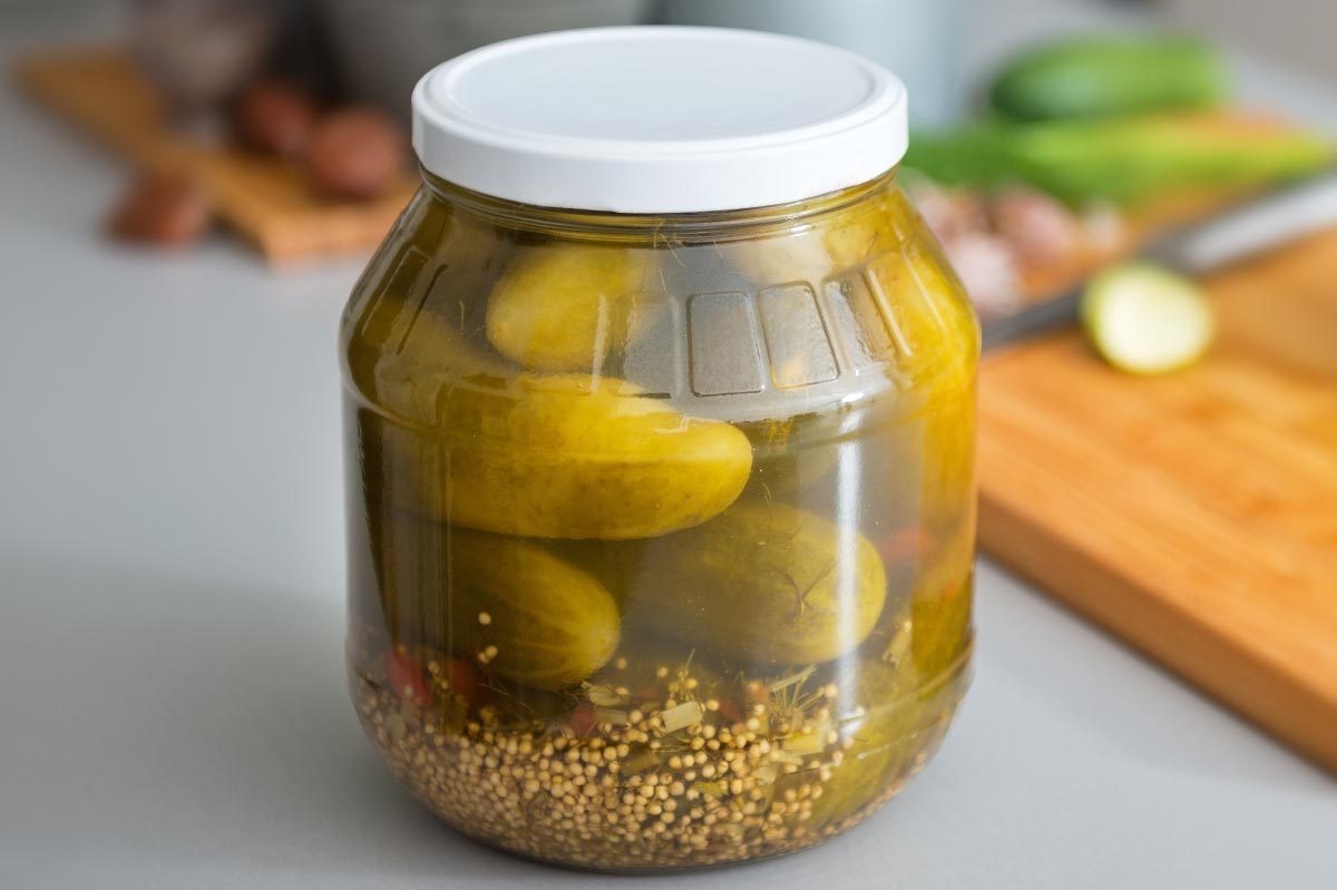 Closeup on jar of pickled cucumbers on table