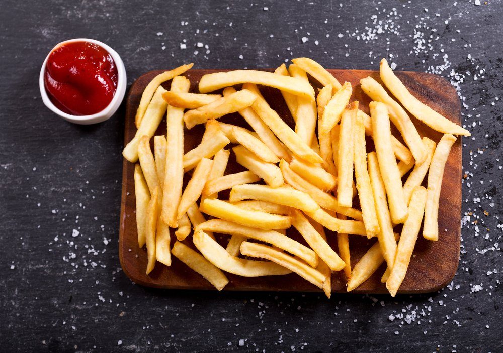 French fries with ketchup on dark background