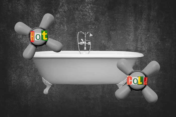 Bathtub With Enlarged Temperature Knobs Labeled Hot And Cold