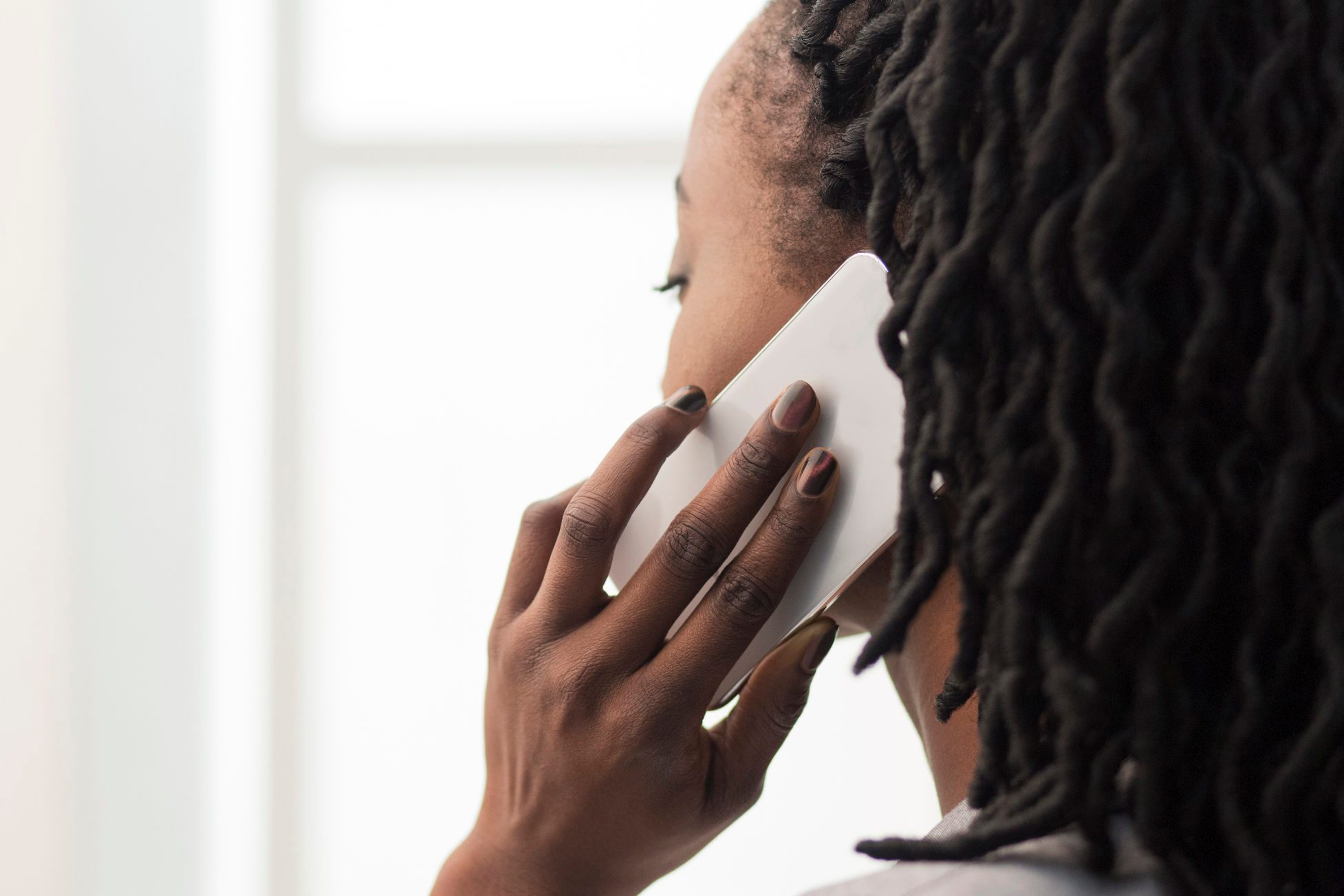 Unrecognizable Businesswoman Talking On Cellphone In Office, Closeup