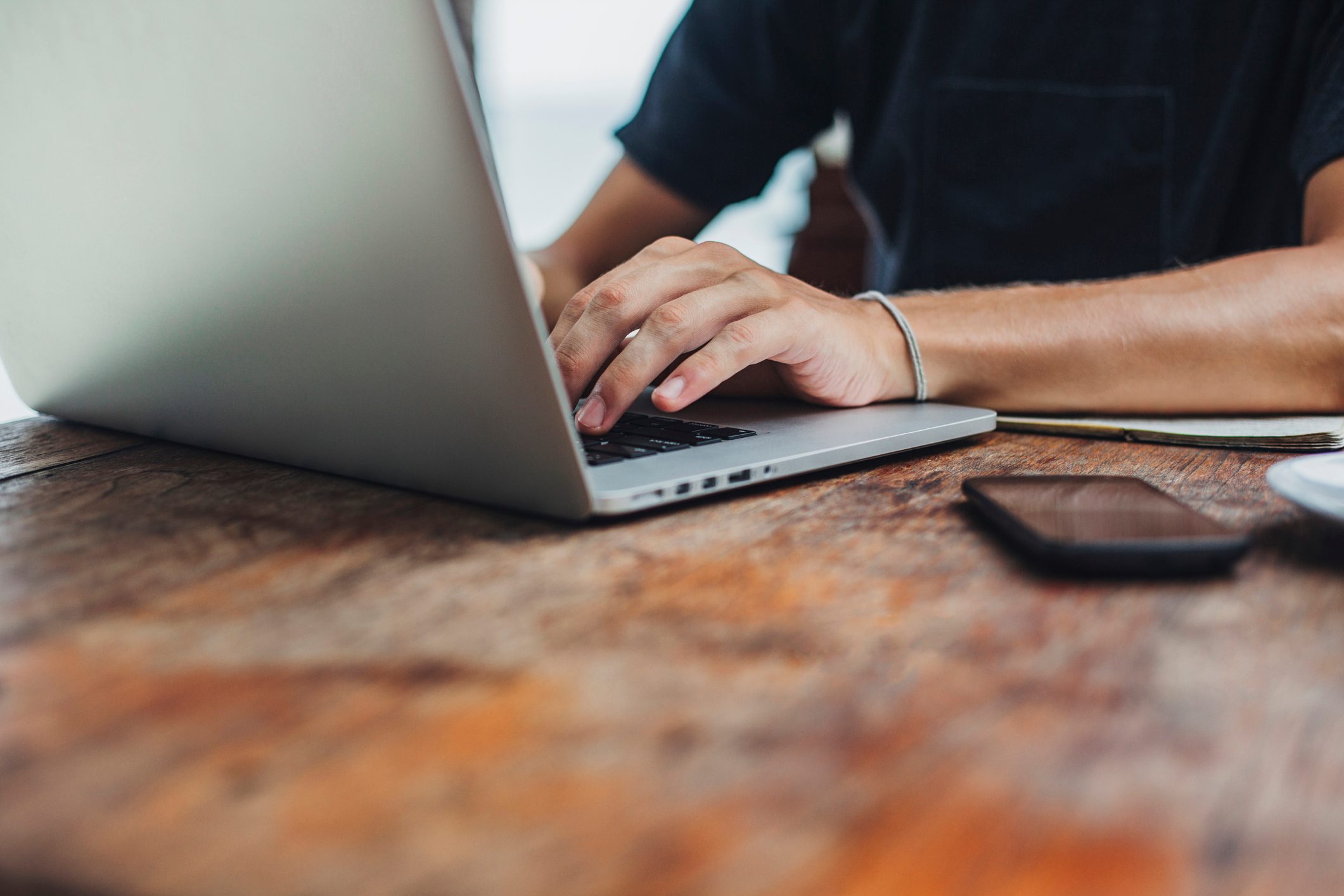 Caucasian man using laptop at table